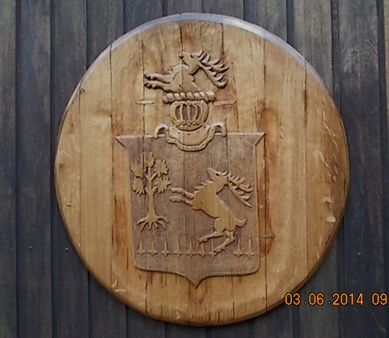 coat of arms carved barrel-end by the Sign Carver