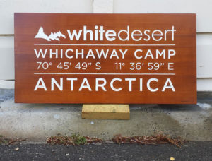 Carved wooden sign for White Desert, Whichaway Camp | Antarctica