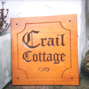 Carved wooden cottage sign crail cottage